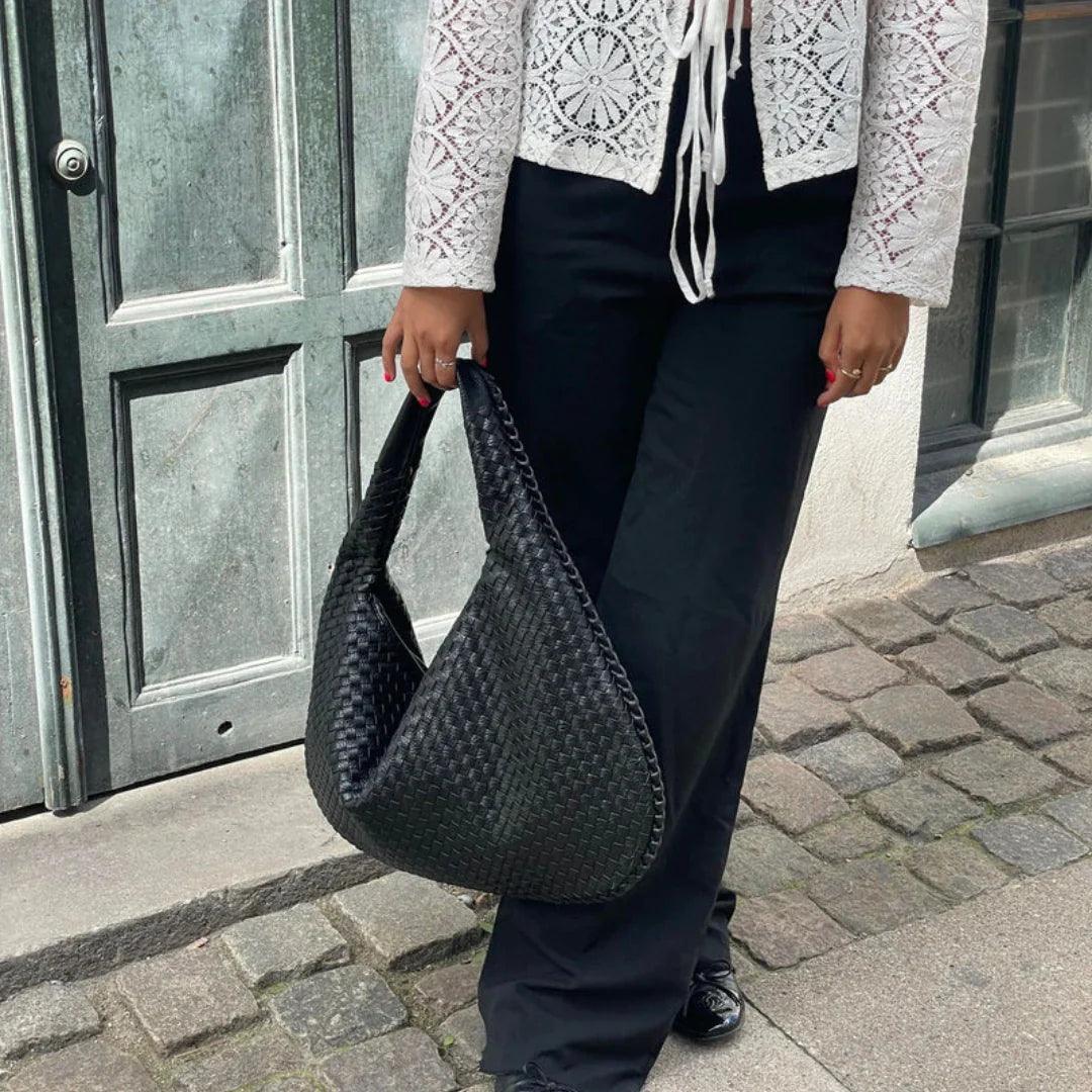 Designer-style woven vegan leather shoulder bag for women, comfortable slouch design.