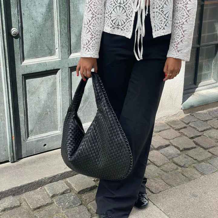 Designer-style woven vegan leather shoulder bag for women, comfortable slouch design.