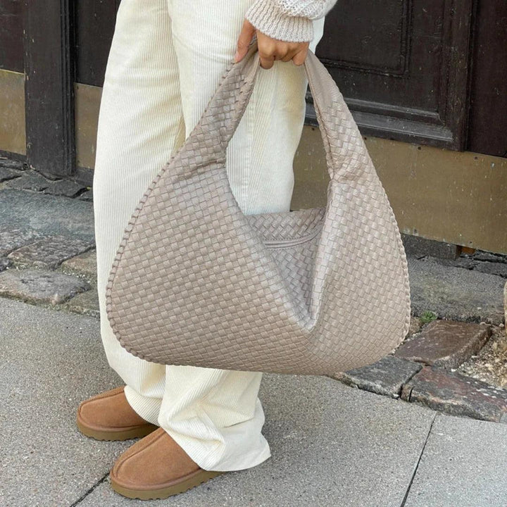 Chic women's soft vegan leather bag, slouchy woven shoulder design, a must-have fashion accessory.