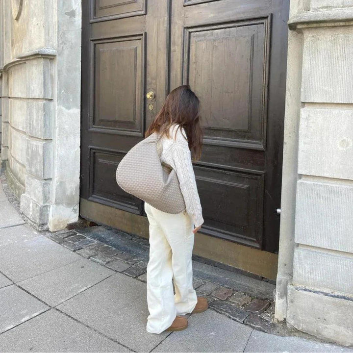 Women's modern soft woven shoulder bag in premium vegan leather, unique slouch style.