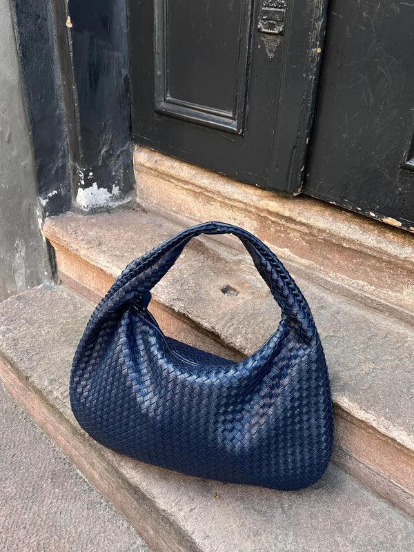 Everyday women's fashion accessory: soft vegan leather woven shoulder slouch bag.