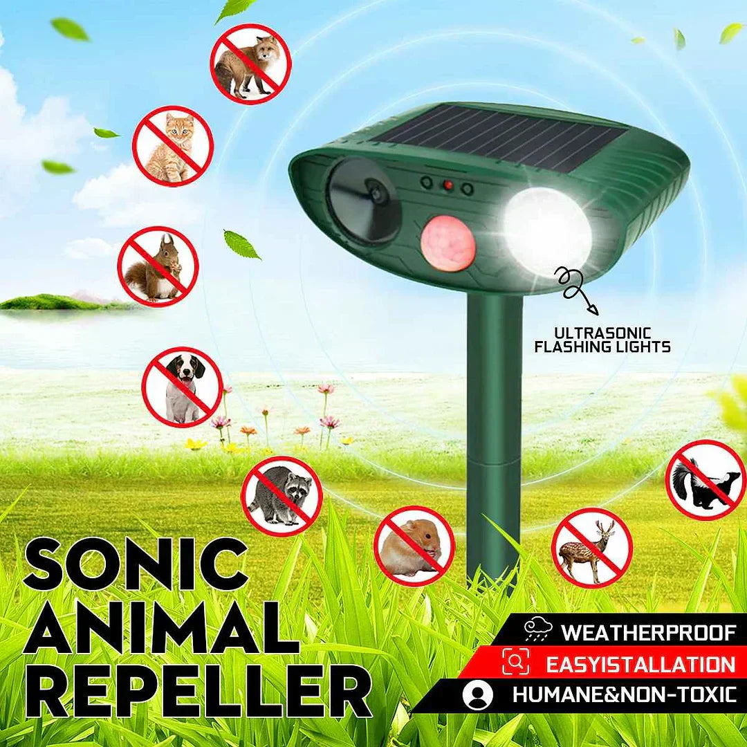 Close-up of a solar-powered deer repeller with a large solar panel for charging.