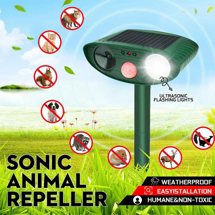 Close-up of a solar-powered deer repeller with a large solar panel for charging.