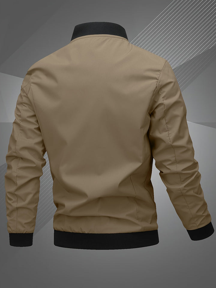 Side profile of a man wearing a modern bomber jacket, highlighting its comfortable outerwear design.