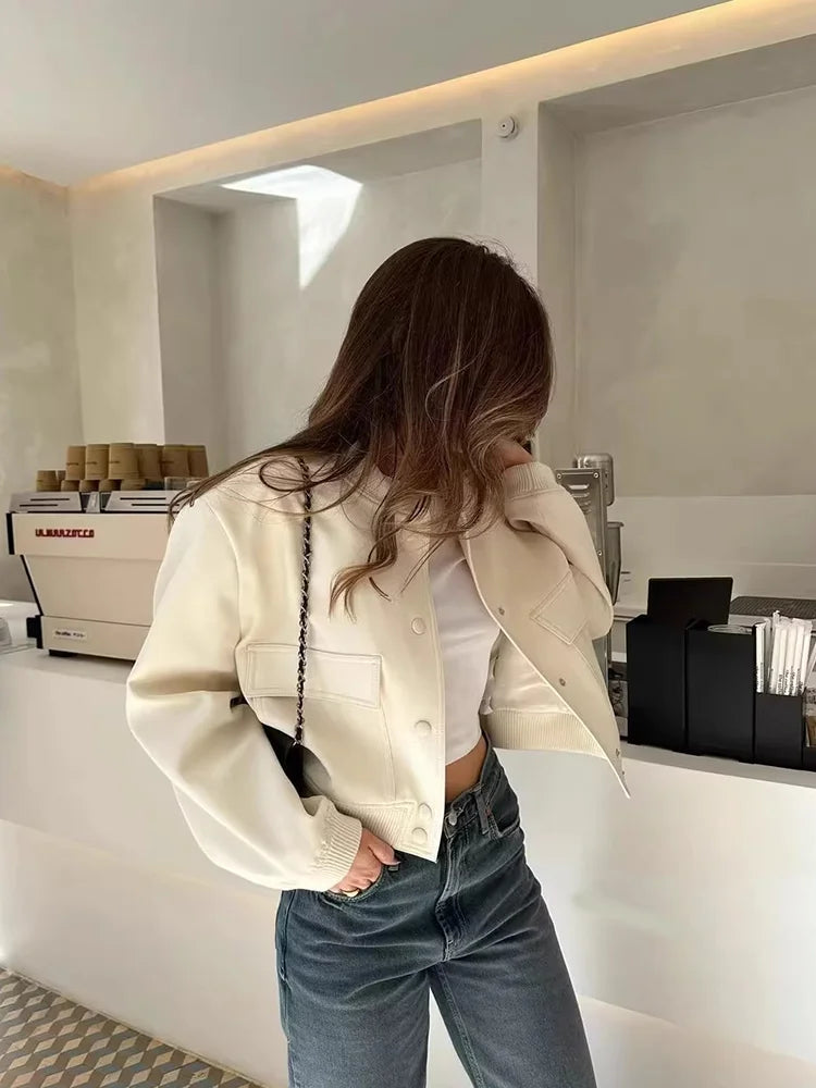 Fashionable women's cropped jacket featuring a full button-front closure and a stylish cut.