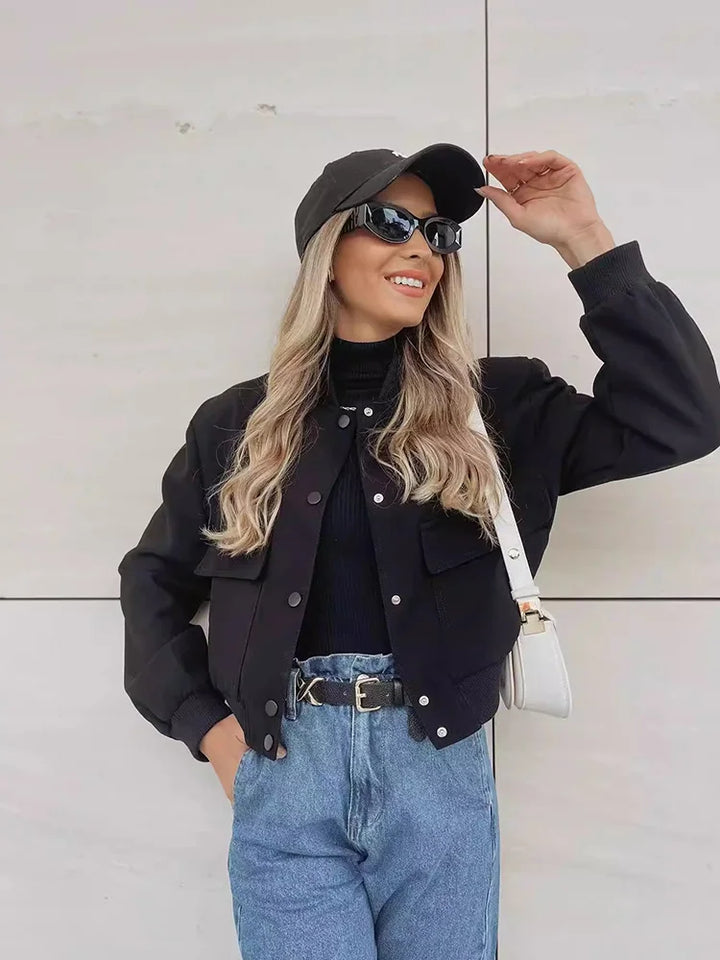 Side profile of a women's cropped jacket with a button front, highlighting its contemporary fit.