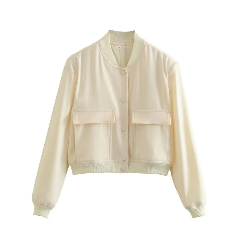 Close-up of the button-front detail on a women's stylish cropped jacket, quality outerwear.