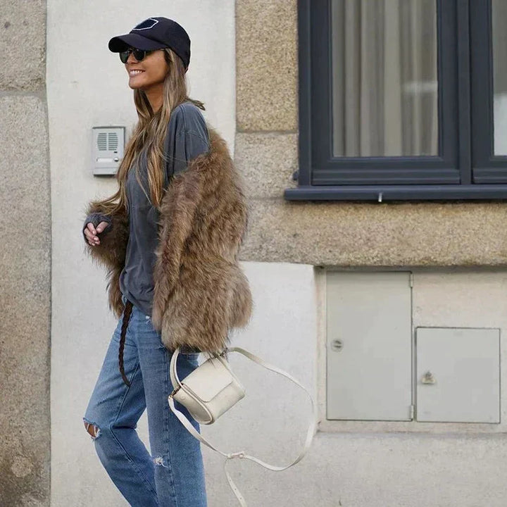 Fashionable cropped women's winter jacket, a versatile piece for glamorous evening outfits or chic casual wear.