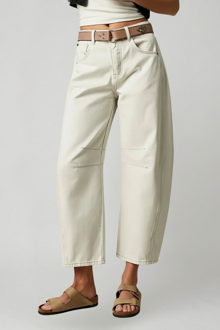 Back view of trendy women's high-waist wide-leg denim jeans, highlighting pocket details.