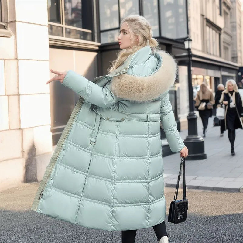 Modern women's long winter coat with a removable fur hood and belted design for versatile styling.