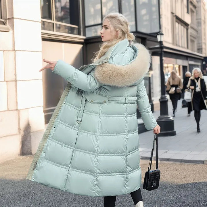 Modern women's long winter coat with a removable fur hood and belted design for versatile styling.
