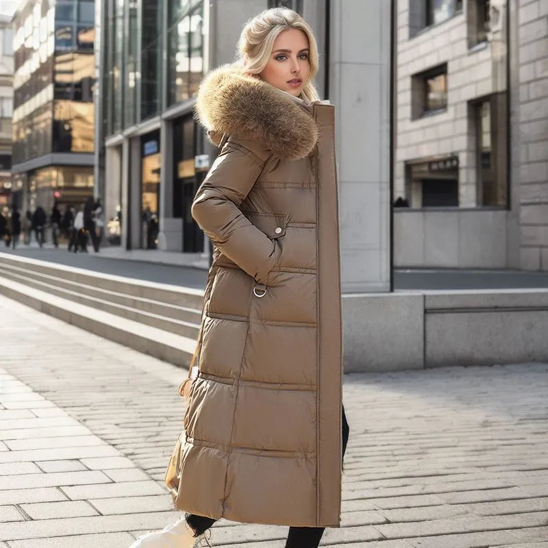 Elegant long winter coat for women, featuring a warm fur hood and a chic belted waist.