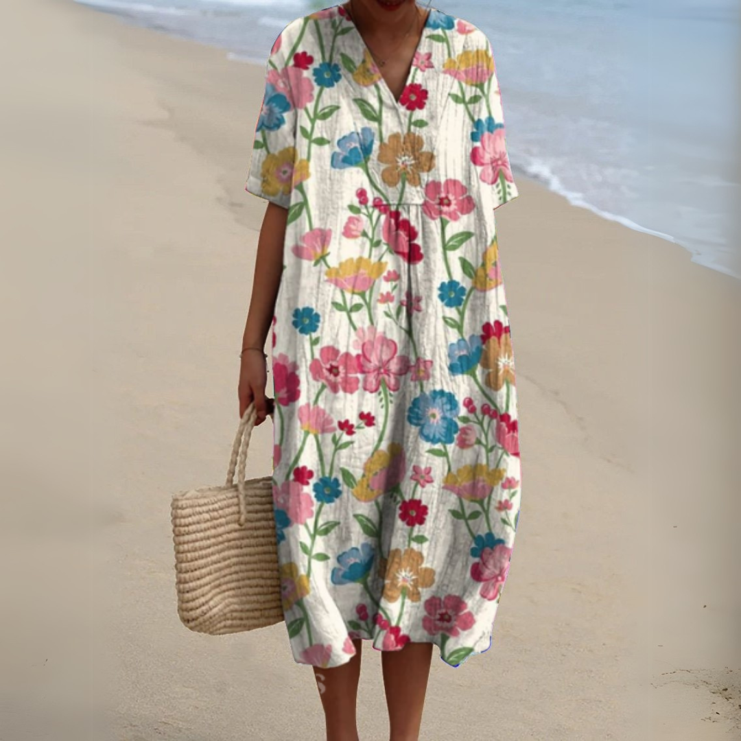 Elegant women's V-neck summer dress in vibrant multicolour floral print, midi length.