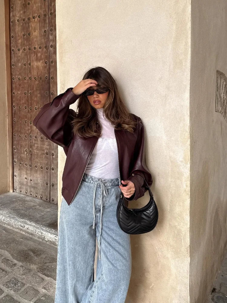 Fashionable women's oversized waist-length leather jacket. A stylish outerwear piece for spring or autumn.