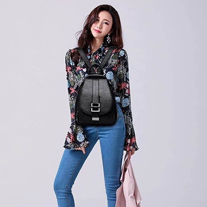 Black leather water-resistant backpack for women, perfect for travel & work.