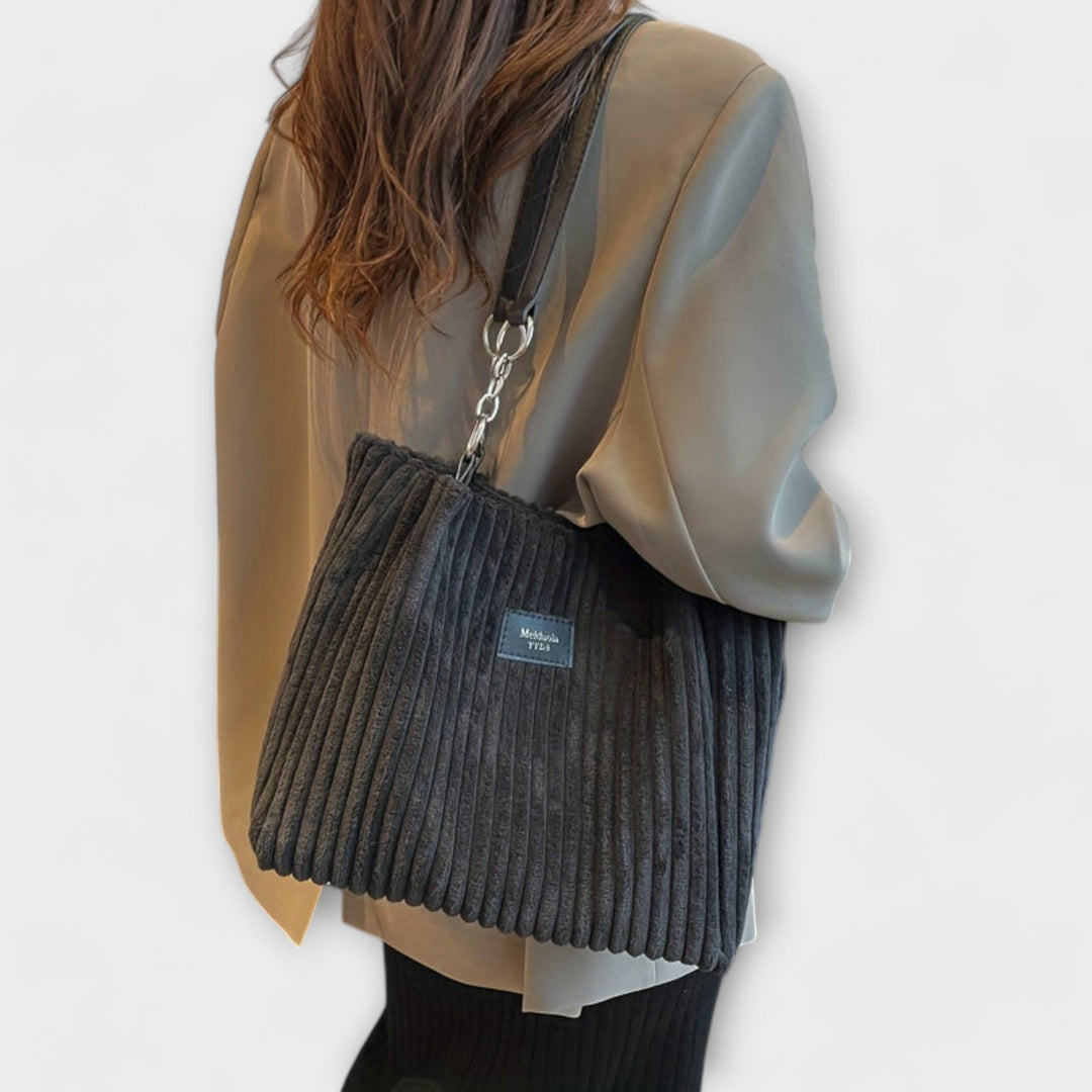 Detailed view of a fashionable women's corduroy shoulder bag with ample storage