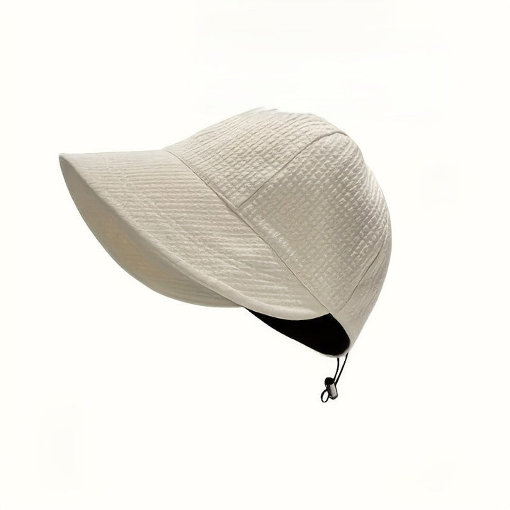 Stylish women's sun protection hat with adjustable drawstring, perfect for beach, travel, and summer activities.