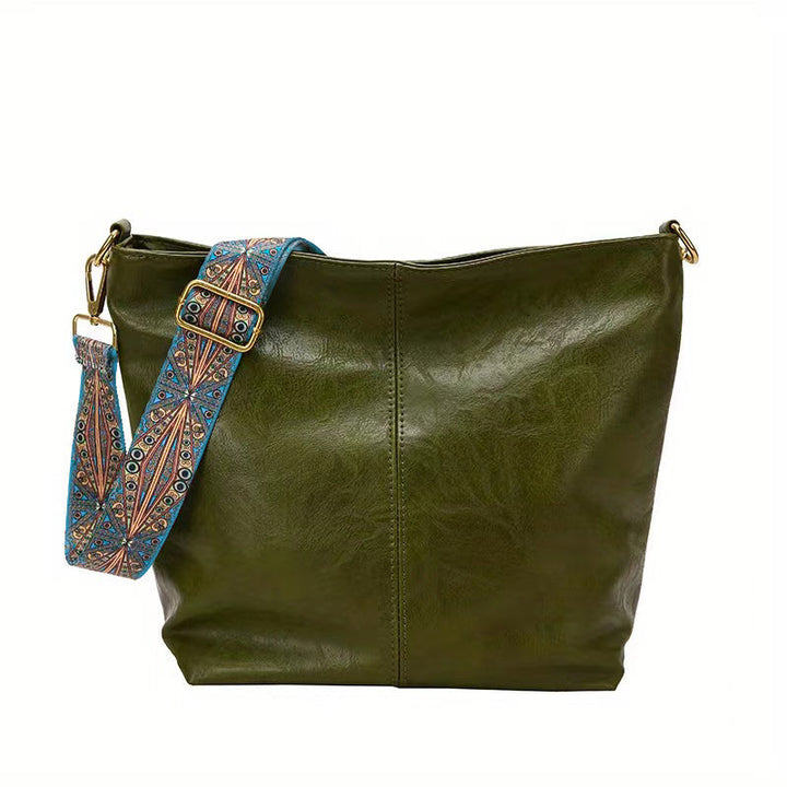 Spacious women's tote bag, a stylish shoulder bag with an elegant design and decorated straps for everyday fashion.