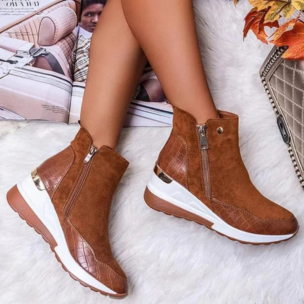 Stylish women's waterproof black leather ankle boots with elastic side panels, perfect for winter fashion.