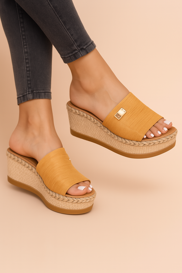 Women's stylish woven wedge sandals. Casual platform footwear for summer. Elegant open-toe design.