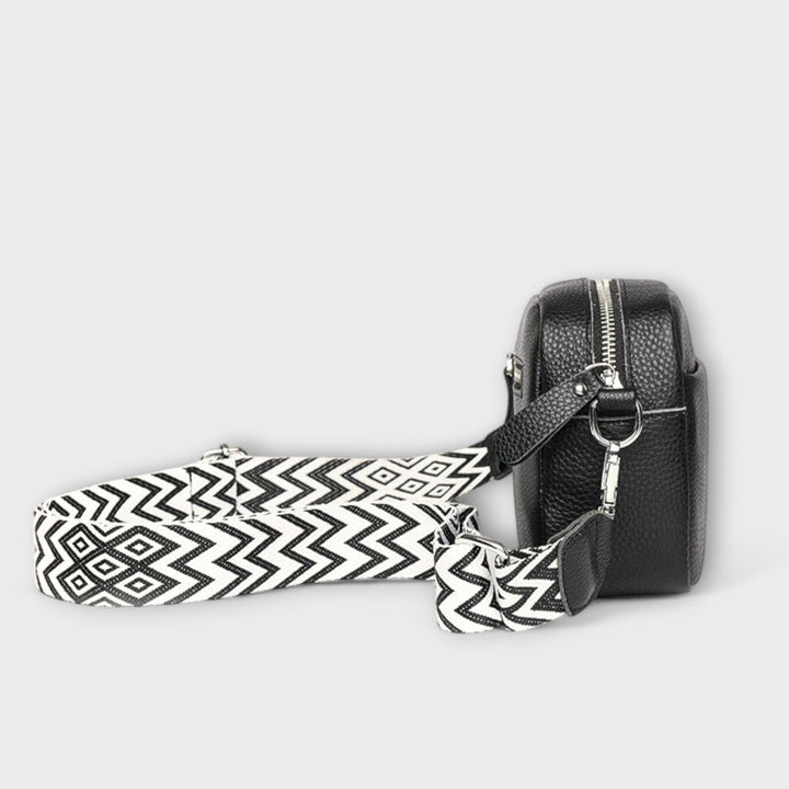 Women's versatile textured mini bag with a bold statement strap, can be worn as crossbody or shoulder bag.