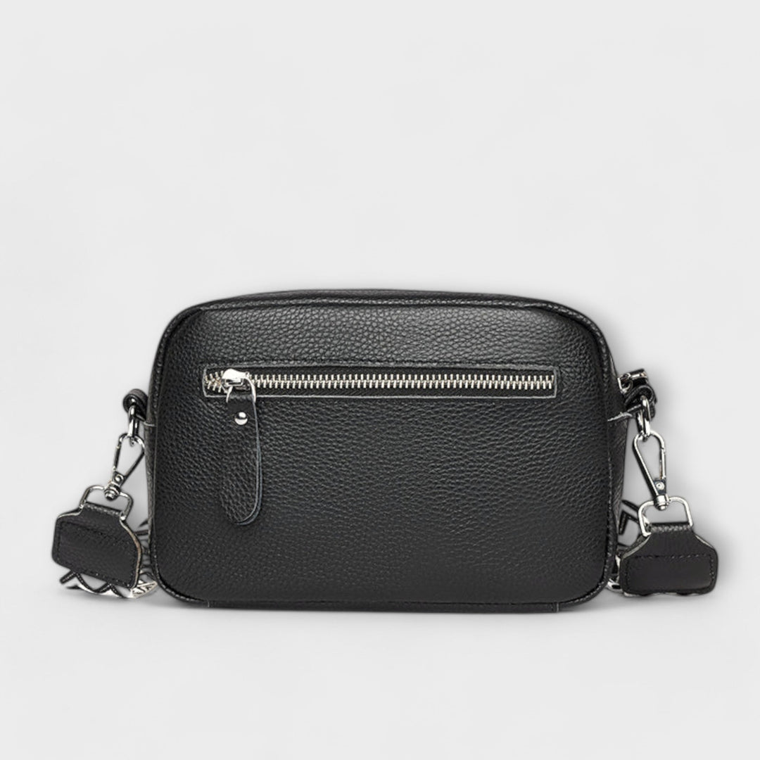 Fashionable women's mini textured crossbody bag with attractive statement strap, a compact accessory.