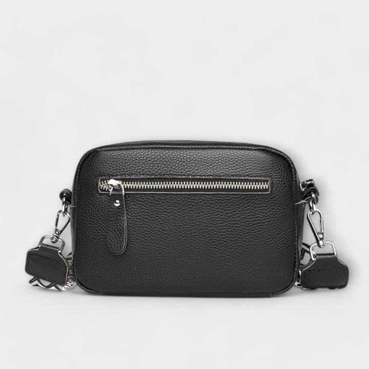 Fashionable women's mini textured crossbody bag with attractive statement strap, a compact accessory.