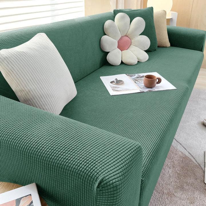 Textured stretch sofa cover against a backdrop of cozy home decor, emphasizing its appeal