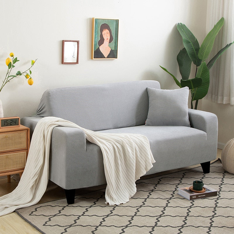 Textured stretch sofa cover's non-slip backing material, ensuring it stays firmly in place