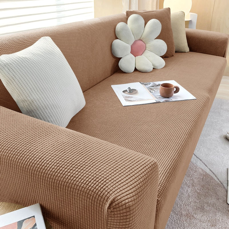 Close-up of textured stretch sofa cover fabric, highlighting its intricate woven pattern
