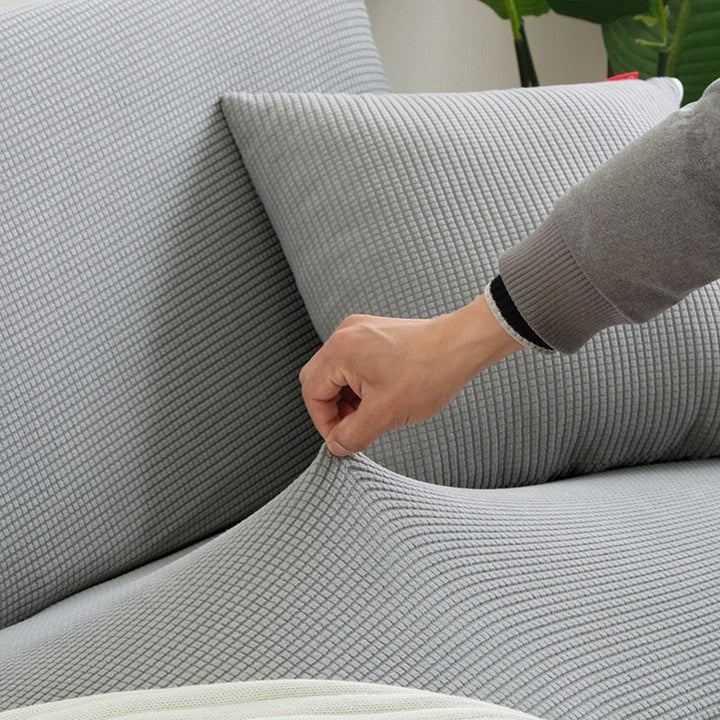 Textured stretch sofa cover in a minimalist setting, highlighting its sleek and clean lines