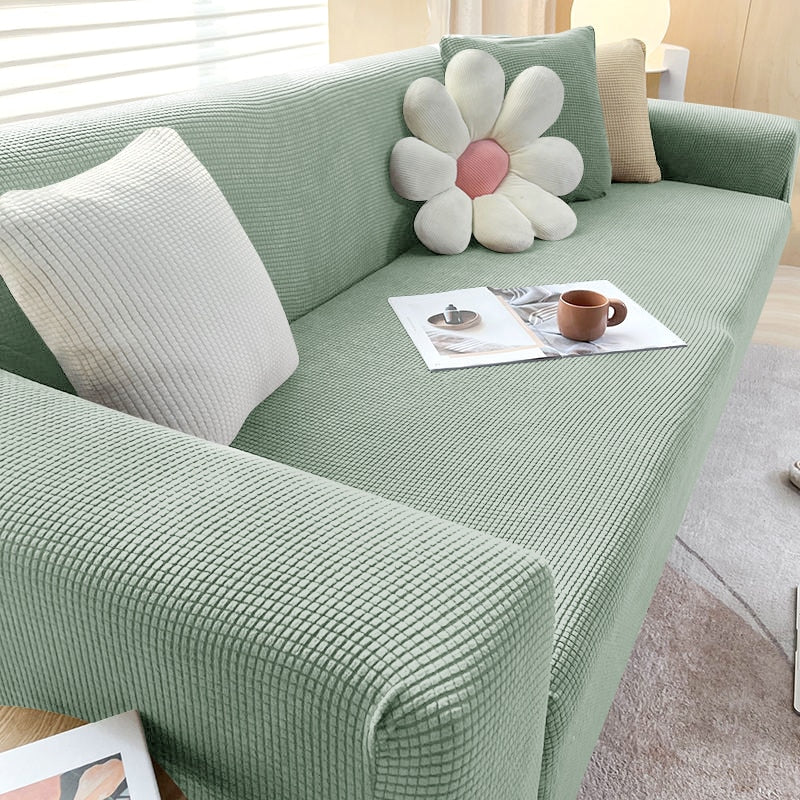 Textured stretch slipcover transforming an old sofa into a fresh, contemporary piece