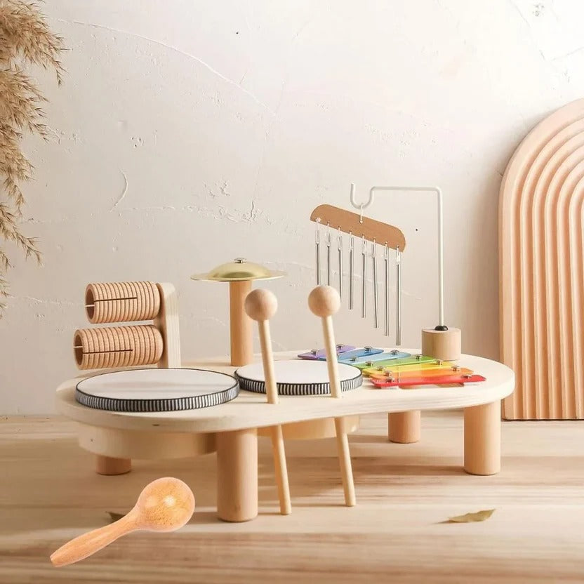 Full view of a Montessori wooden drum kit, xylophone, and mallets, designed for toddler musical education.