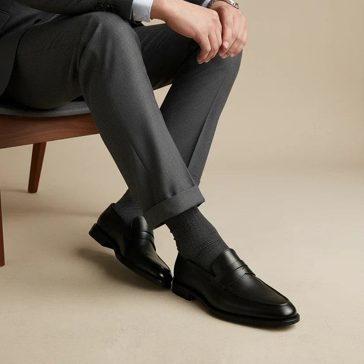 Classic men's black penny strap slip-on loafers. Polished leather smart dress shoes for versatile wear & comfort.