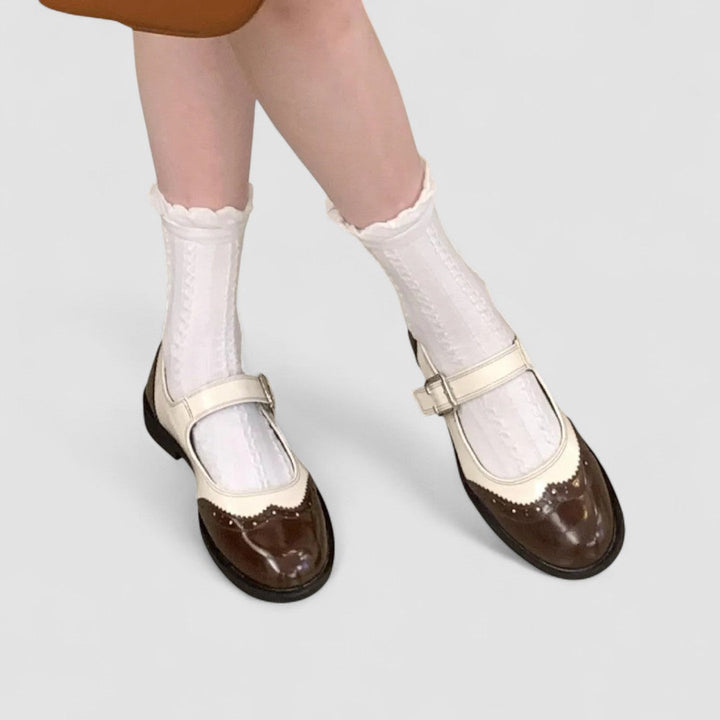 Comfortable women's Mary Jane shoes by Tracy London, featuring orthopedic support and a timeless two-tone flat design.