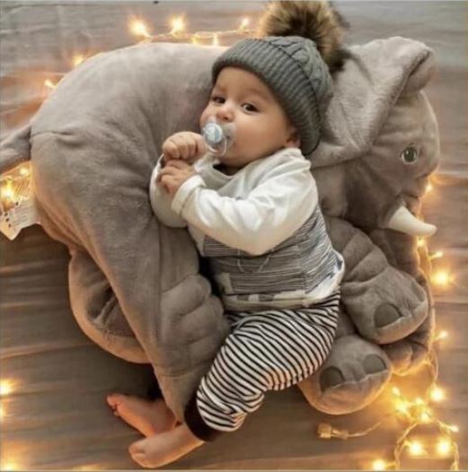 Huggable plush elephant toy, a soft cuddle pillow for kids' room decor and restful baby sleep.