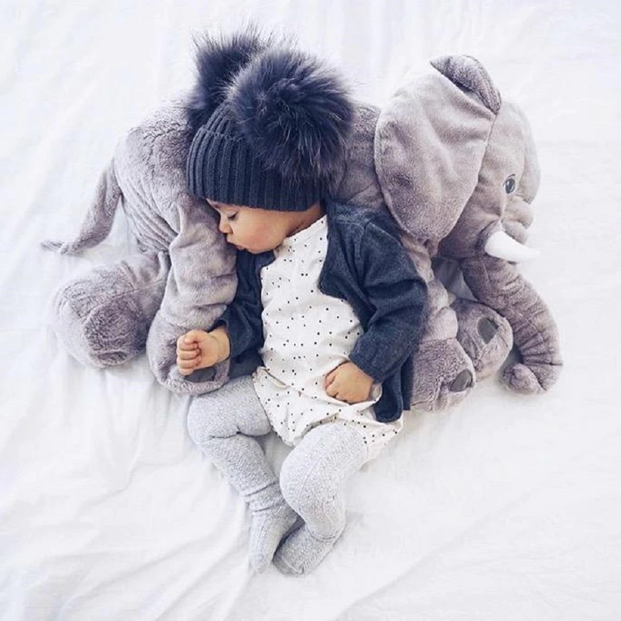 Cute baby elephant cuddle pillow, a soft and huggable plush toy for adorable nursery decor.