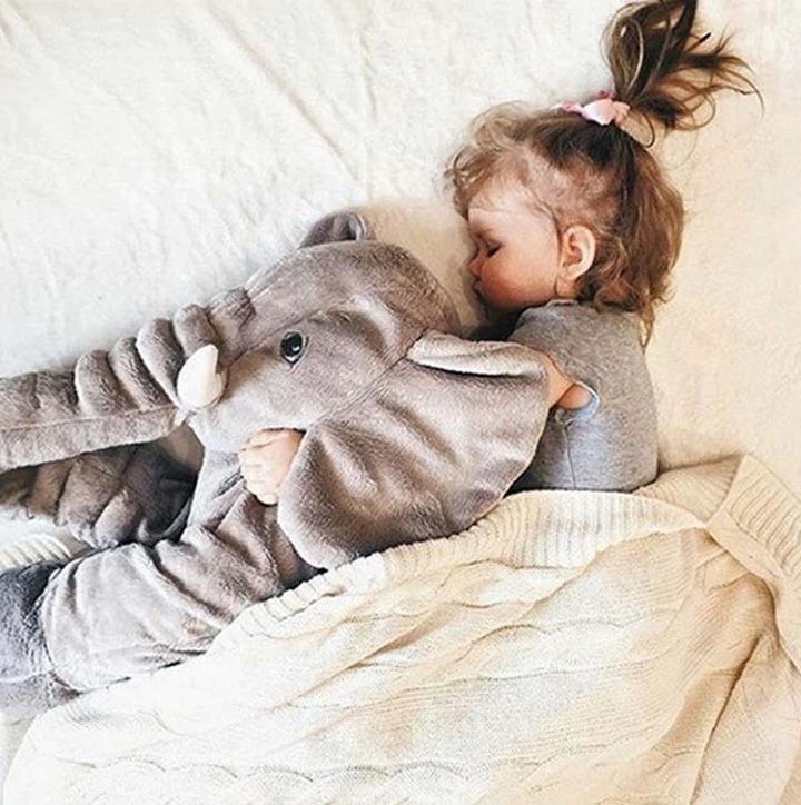 Gentle grey elephant plush toy, an ultra-soft cuddle pillow for infant comfort and room decor.