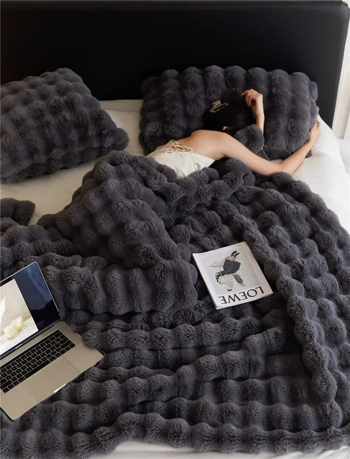 Luxurious fleece throw blanket, ideal for home decor. Provides warm, soft comfort for any space.