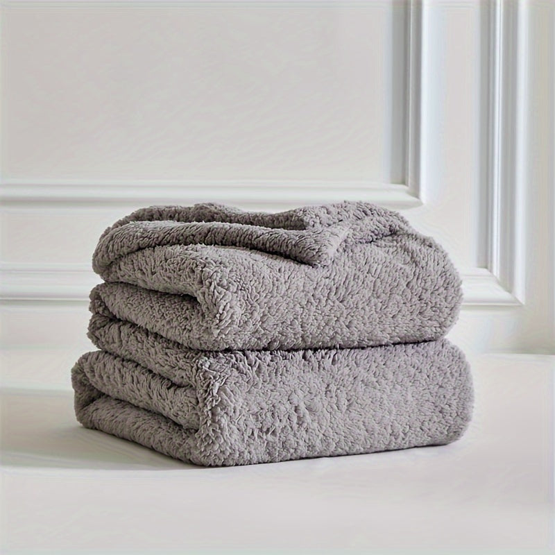 Luxurious soft sherpa fleece throw, warm and inviting for a cozy bed or sofa.