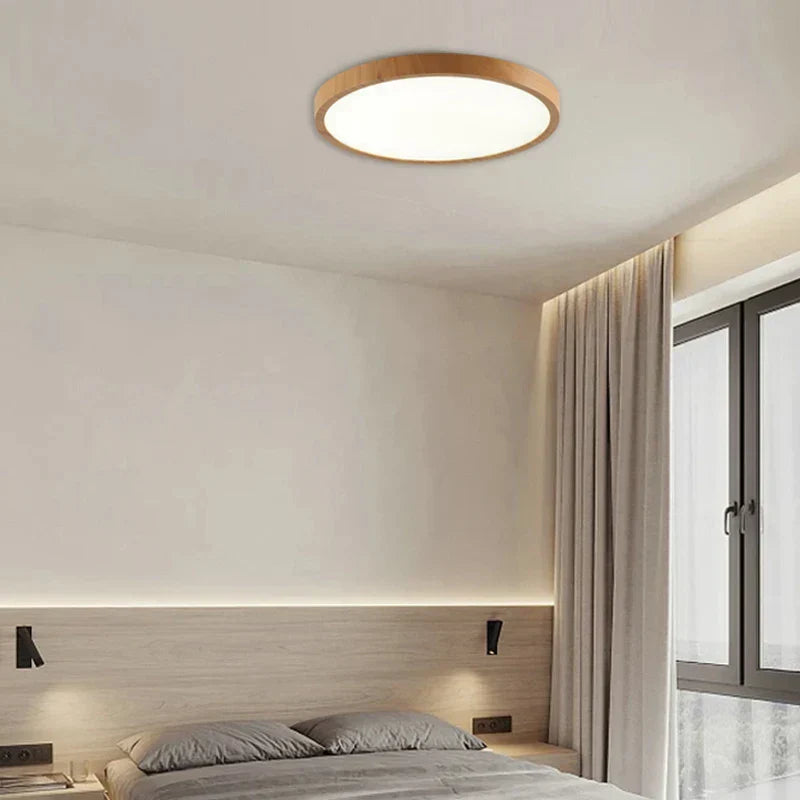 Sleek, ultrathin circular walnut ceiling lamp. Minimalist LED lighting for modern bedroom and dining room spaces.
