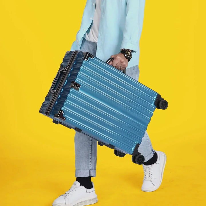 Unisex aluminum frame hard-shell suitcase in an airport setting. Secure and durable luggage for modern travelers.