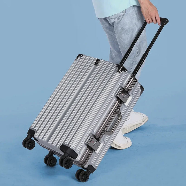 Full view of a sleek unisex aluminum frame hard-shell suitcase. Secure, durable travel luggage with spinner wheels.