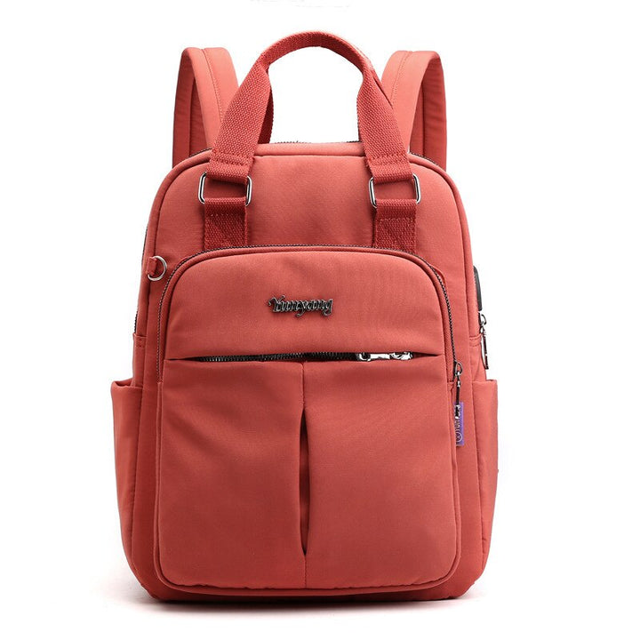Front view of anti-theft backpack with USB port. Water-resistant, sleek design for urban travel and tech.