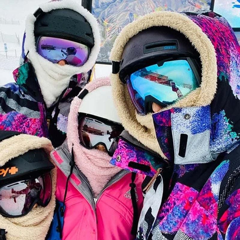 Hiker wearing a warm, windproof ArcticShield 3-in-1 winter hat in snowy mountains. Great for cold.