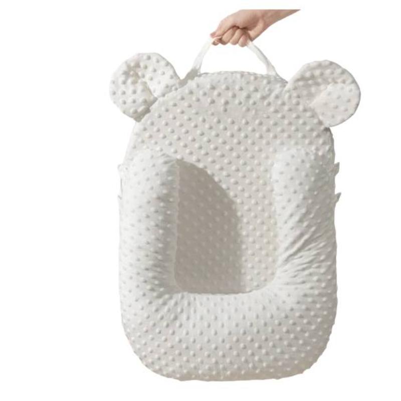 Ergonomic infant feeding wedge pillow for optimal posture support, reducing spit-up in newborns.