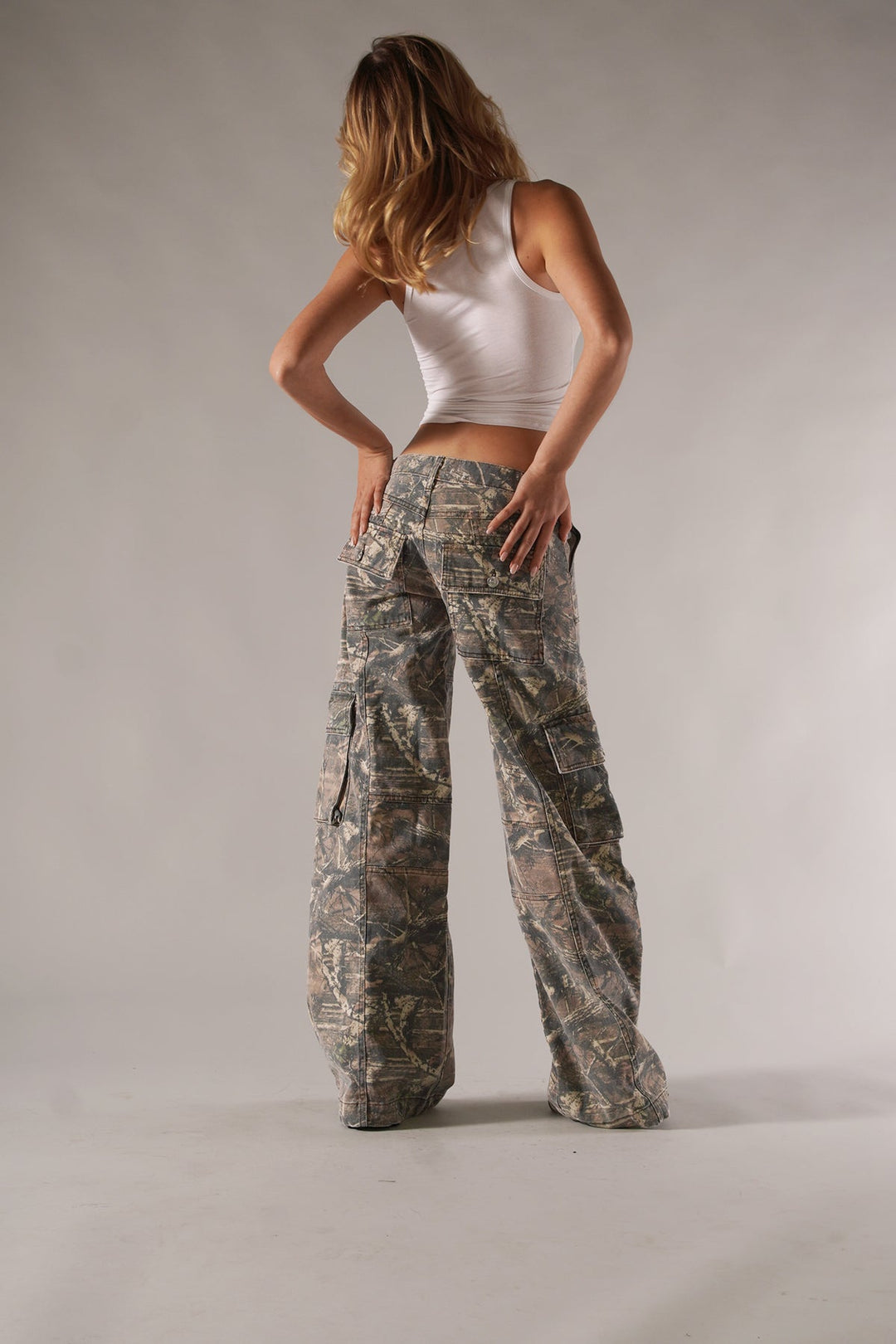 Fashionable women's camo cargo pants with spacious pockets, great for trendy outfits.
