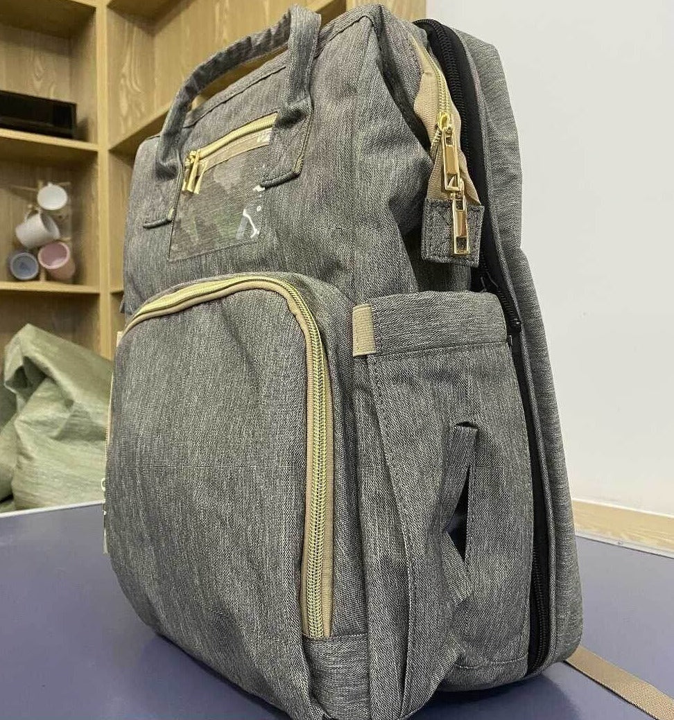 Travel-ready convertible diaper backpack & foldable bassinet for baby. Unisex, multi-pocket, waterproof.