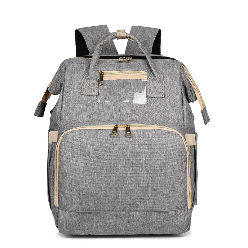 Stylish unisex travel diaper bag with a convenient fold-out bassinet. Essential for on-the-go parents.