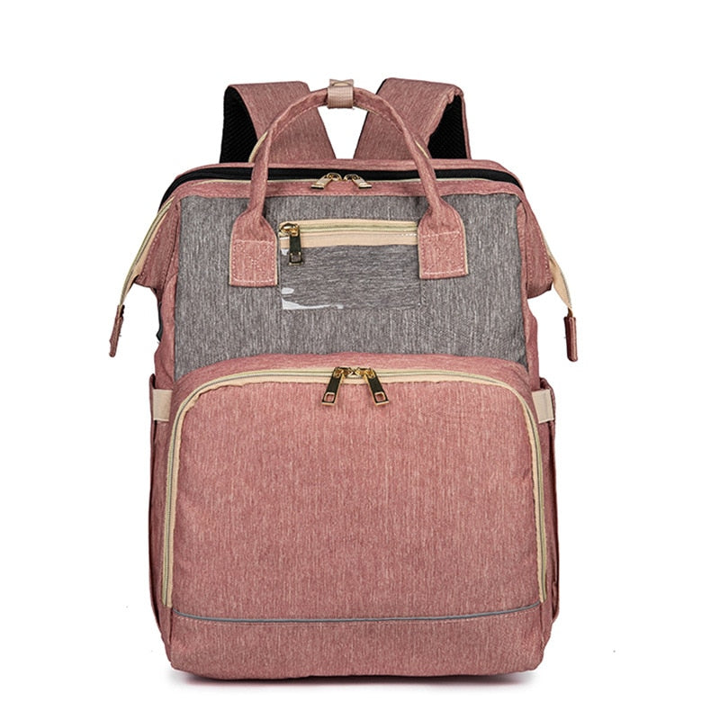 Versatile diaper backpack for travel, converts to a safe, comfortable foldable baby bassinet. Multi-pocket design.